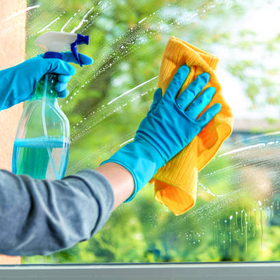 Cleaning window pane with detergent, spring cleaning concept